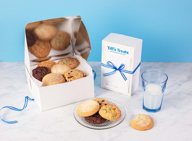 display of cookies in a box and plate with a glass of milk