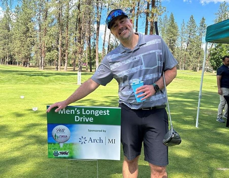 Luke Baker by longest drive sign