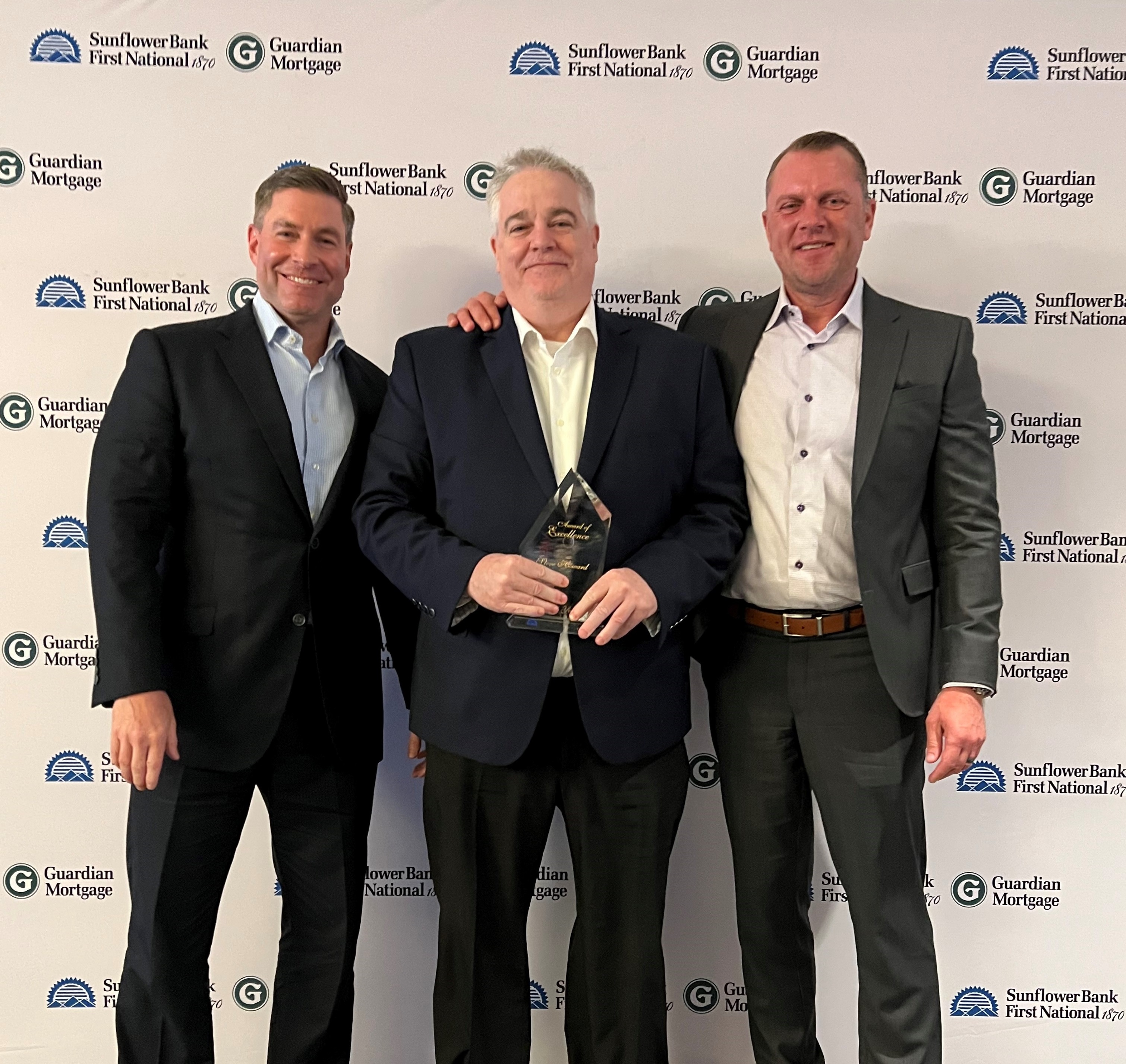 Steve Howard holding Award of Excellence with Marcus McCue and Josh Martin at Sales Excellence Retreat