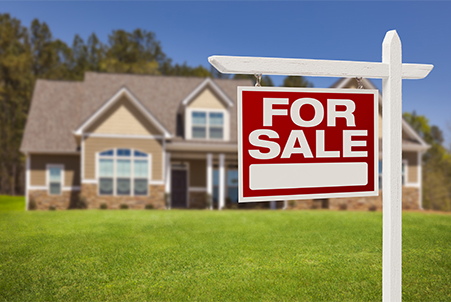 For Sale sign in front of house