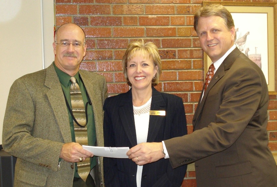 three people smiling with check