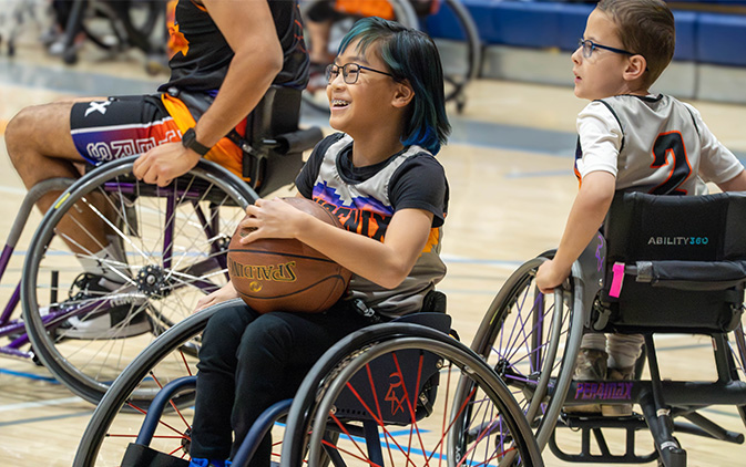 Ability360 - 2 adaptive athletes playing basketball