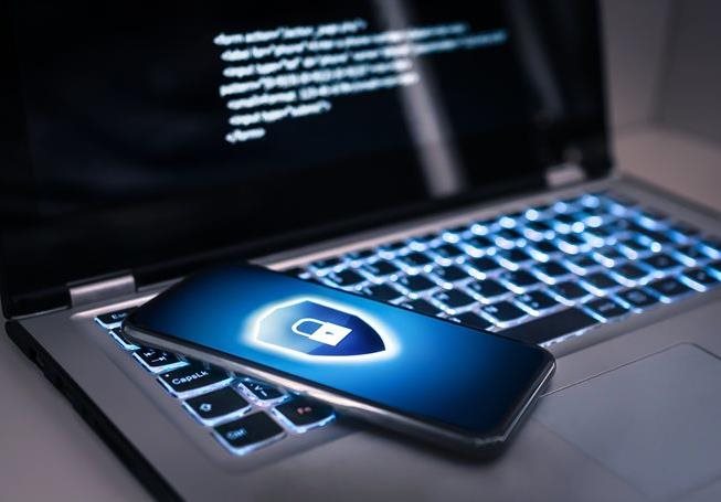 Phone with safelock logo on laptop