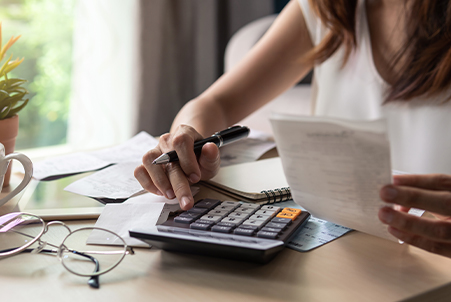 woman pressing calculator