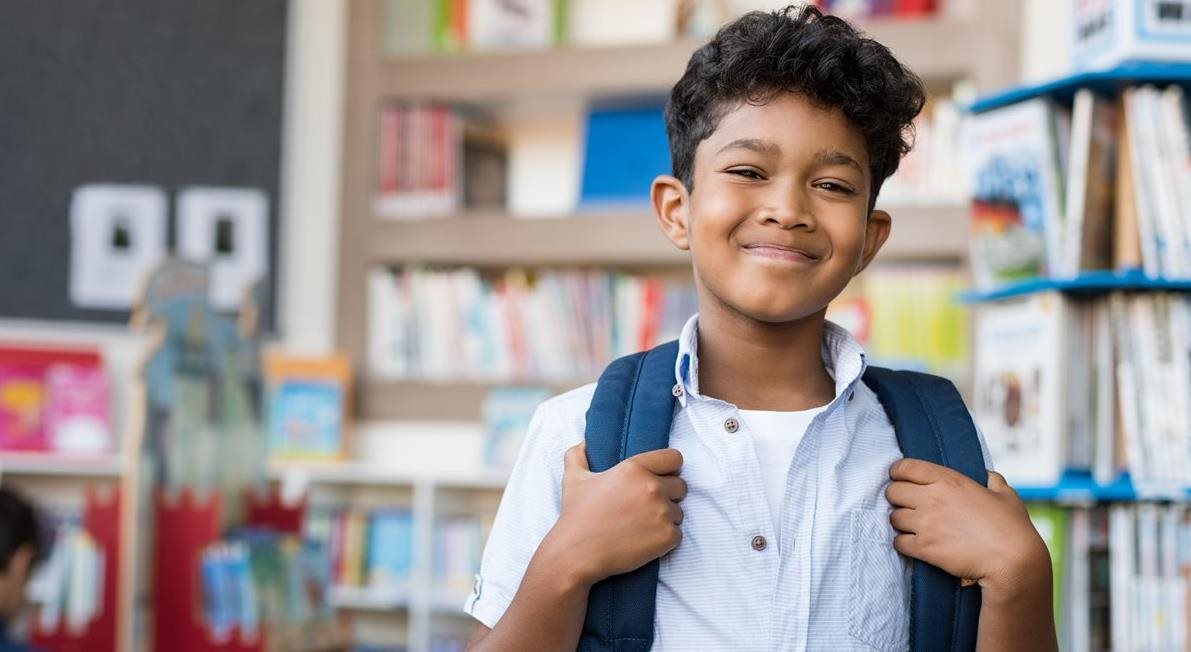 kid smiling with backpack