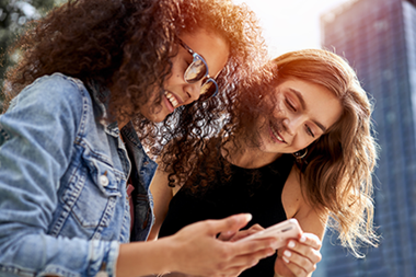 two girls looking at phone