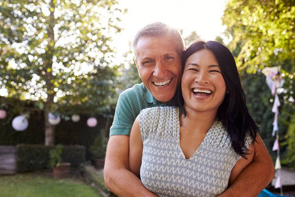 man holding woman smiling together