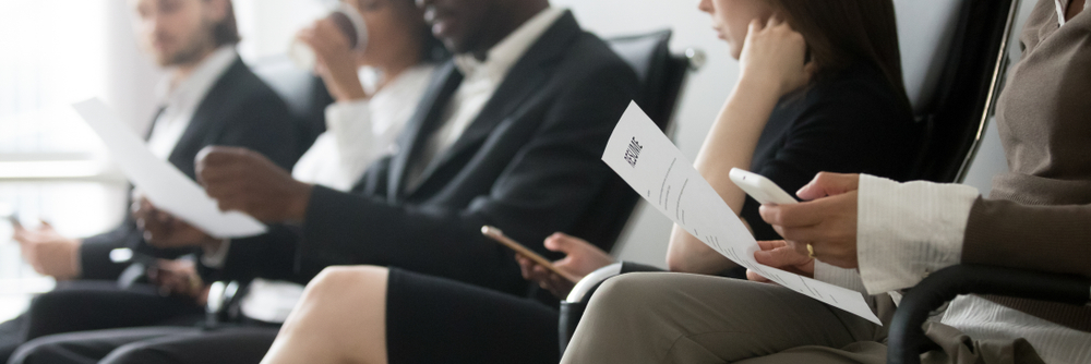 people wearing suits holding paper