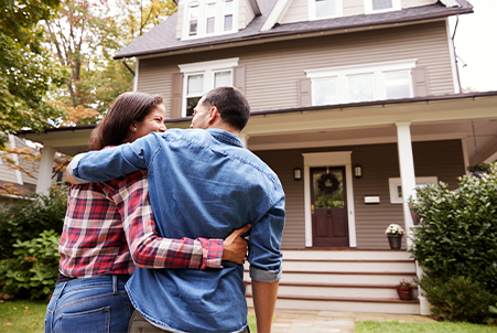 couple in front of house