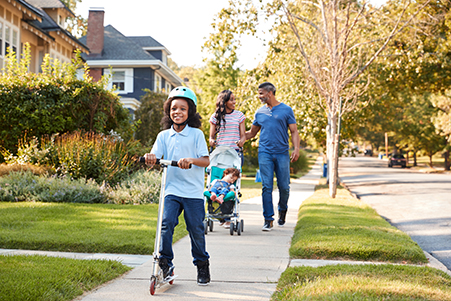 family taking a walk in neighborhood
