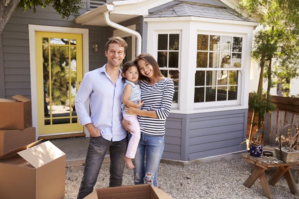 couple standing outside of house