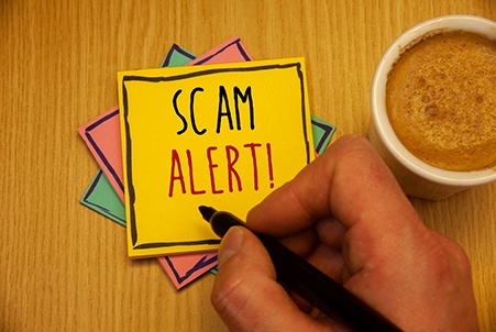 person writing scam alert