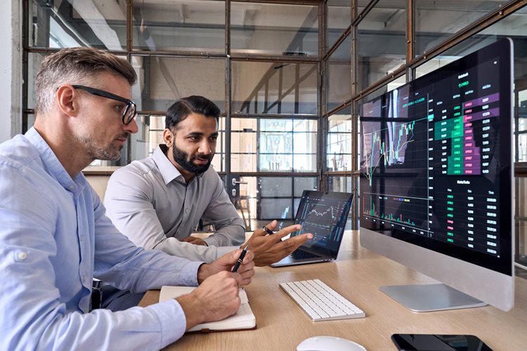 two men looking at computer screen