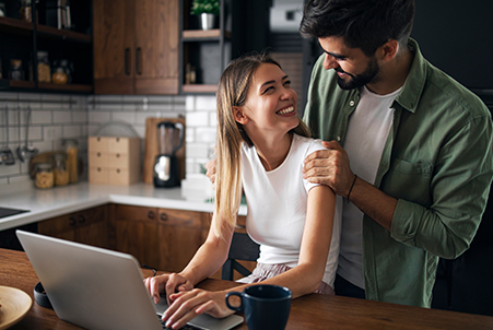 woman on laptop looking at man