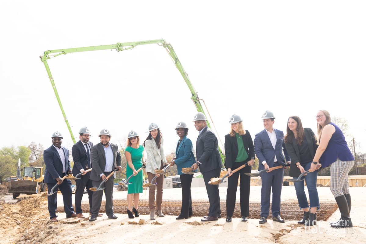 group of people with hard hats and shovels at Kiva groundbreaking