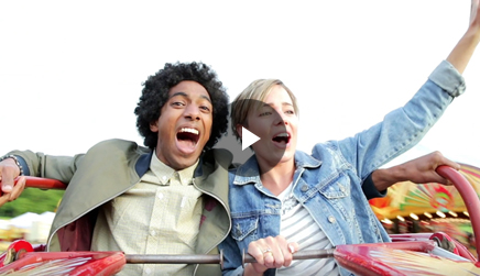 Two individuals on an amusement park ride