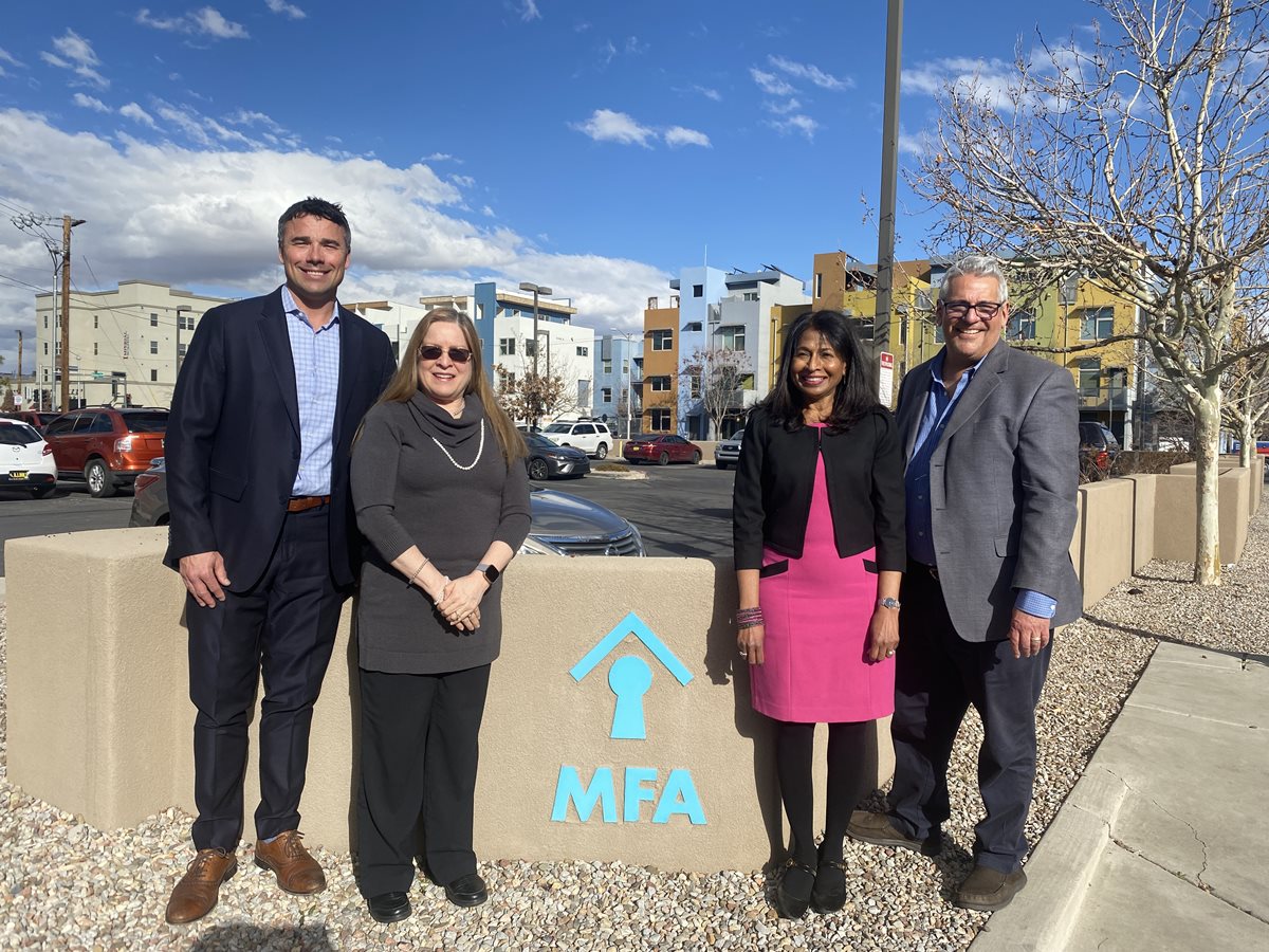 Four individuals standing around an MFA sign outside