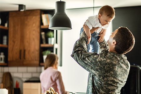 soldier holding kid up