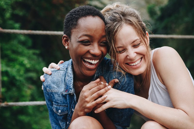 two women laughing together