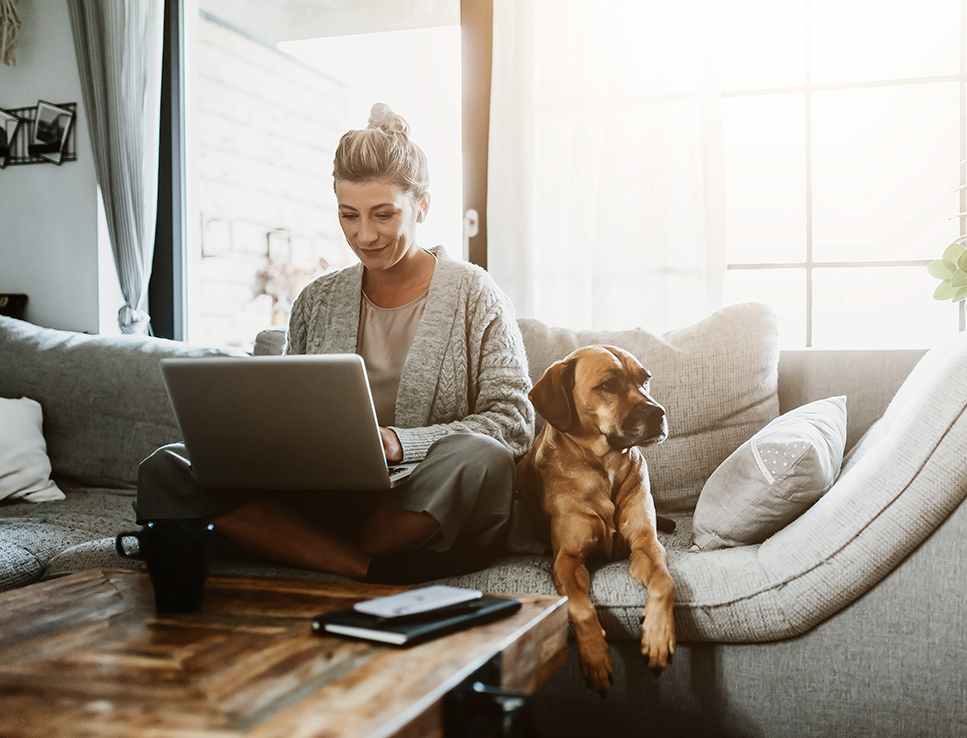 woman on laptop with her dog
